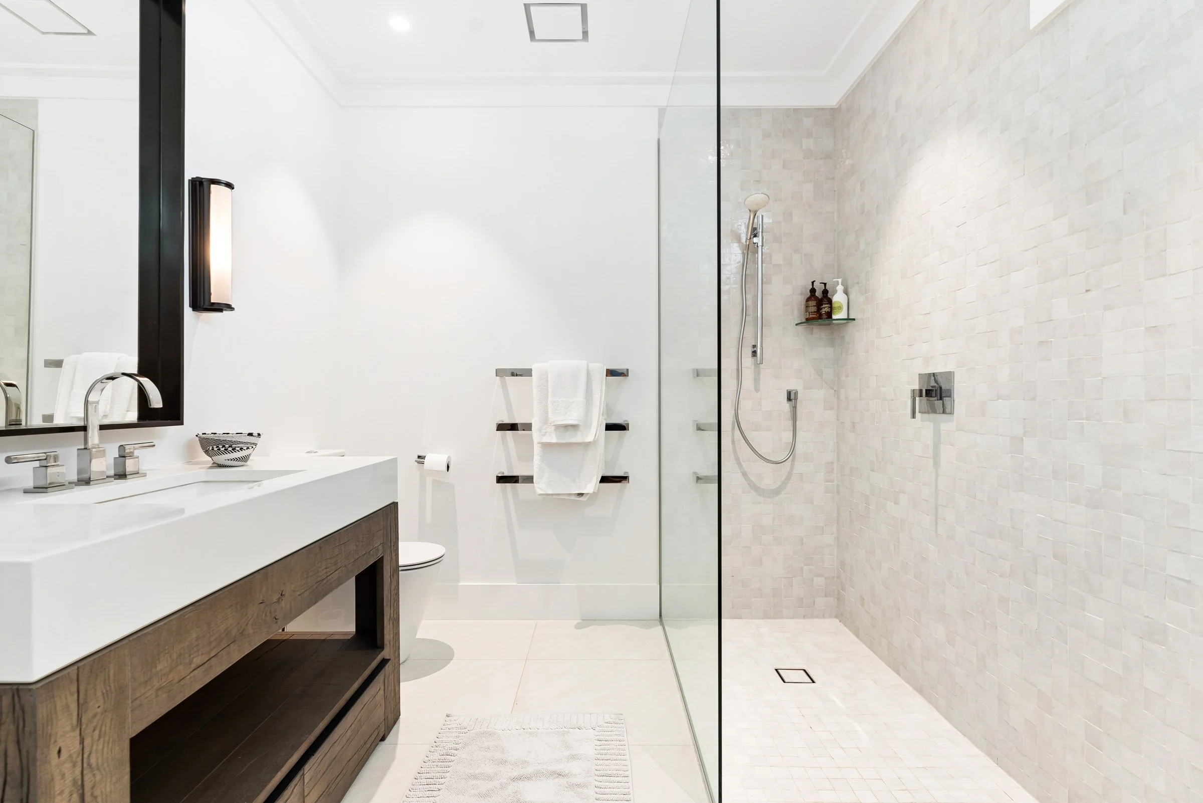 An ensuite in the Main House at Bluestone Estate with a timber vanity and a tiled walk-in shower.