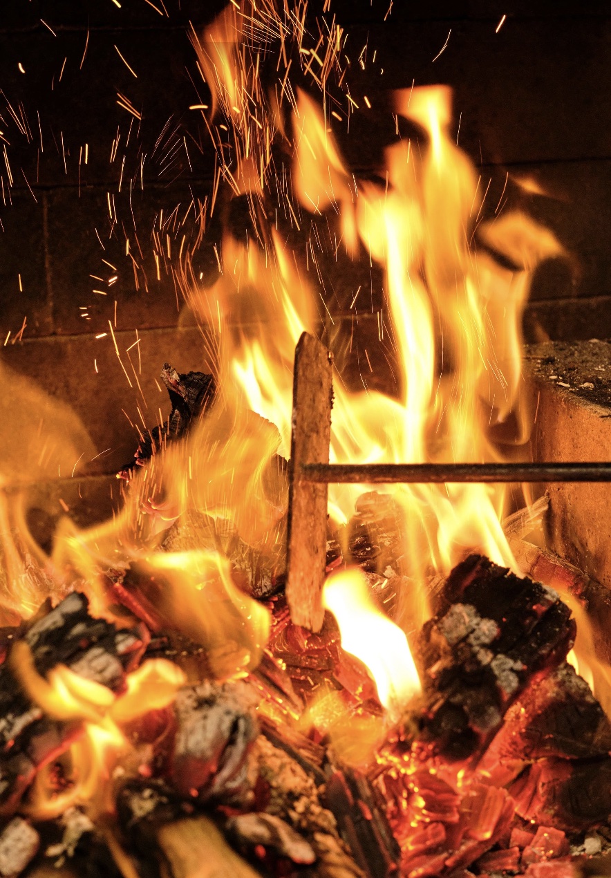 Rothko at Sculptureum, Matakana: flames and flying sparks over glowing embers in the wood-fired grill.